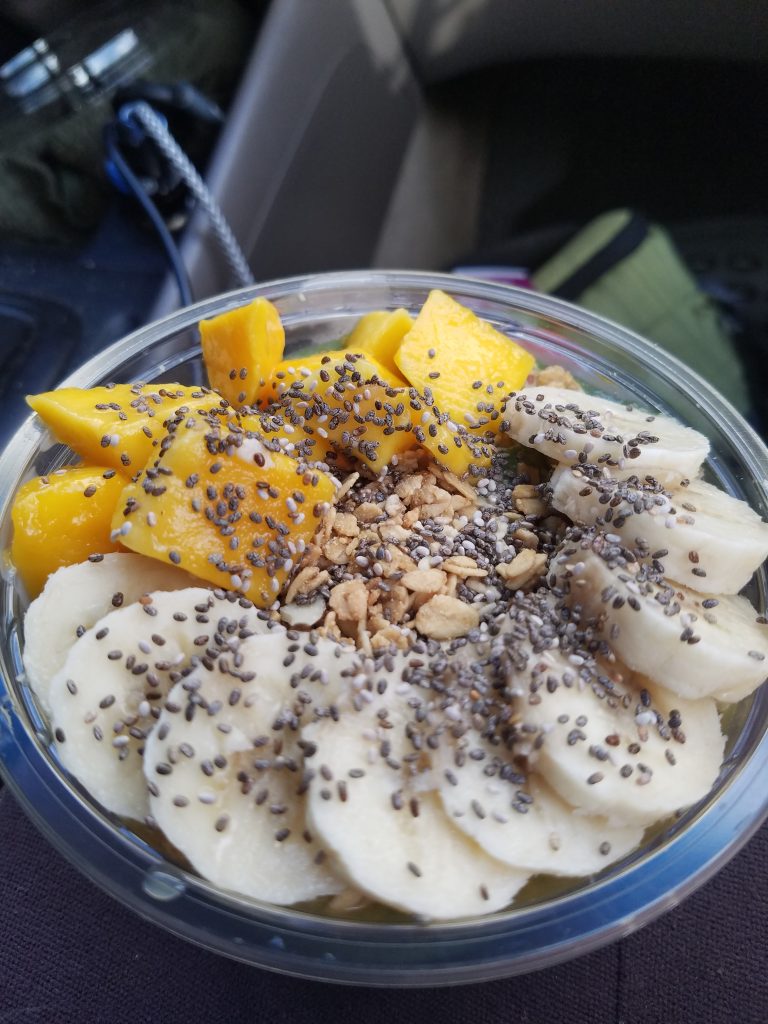 Green Smoothie bowl topped with bananas, mango and chia seeds.