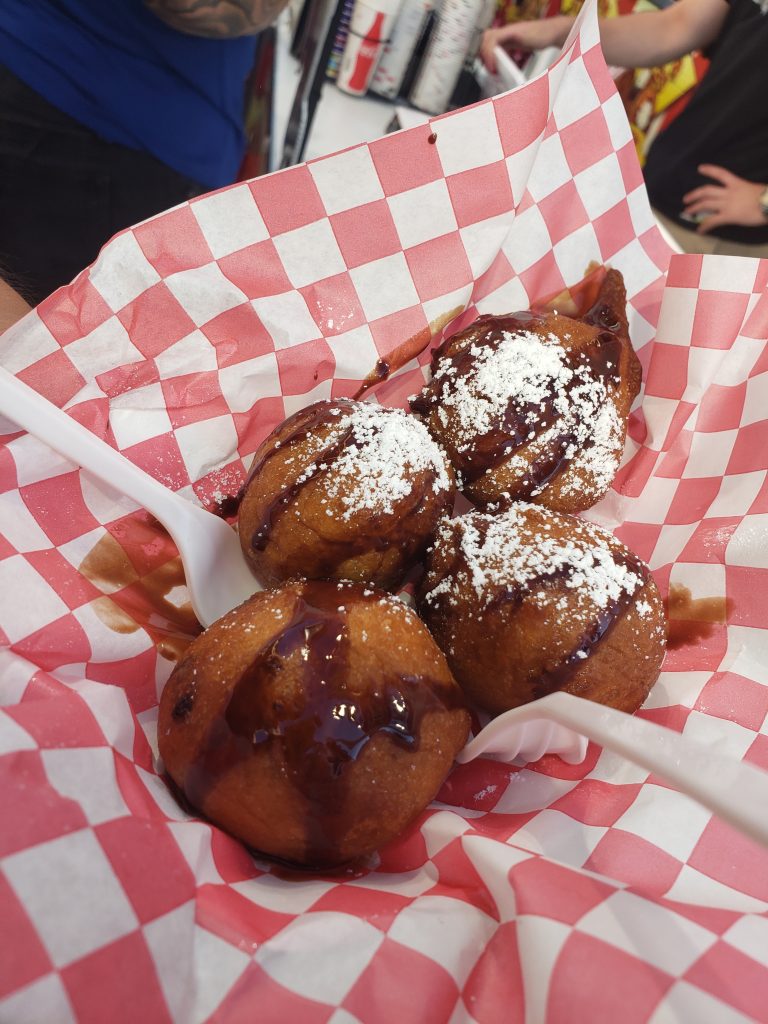 Deep Fried Cookie Dough topped with chocolate sauce and powdered sugar