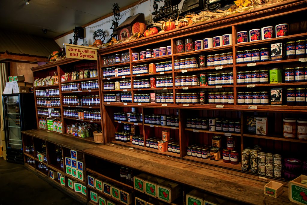 Shelves full of jams, butters and other jar food. 