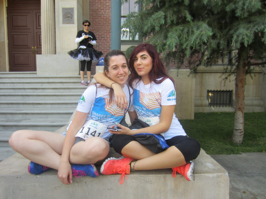 Two girls hugging at a melanoma 5K at Universal studios