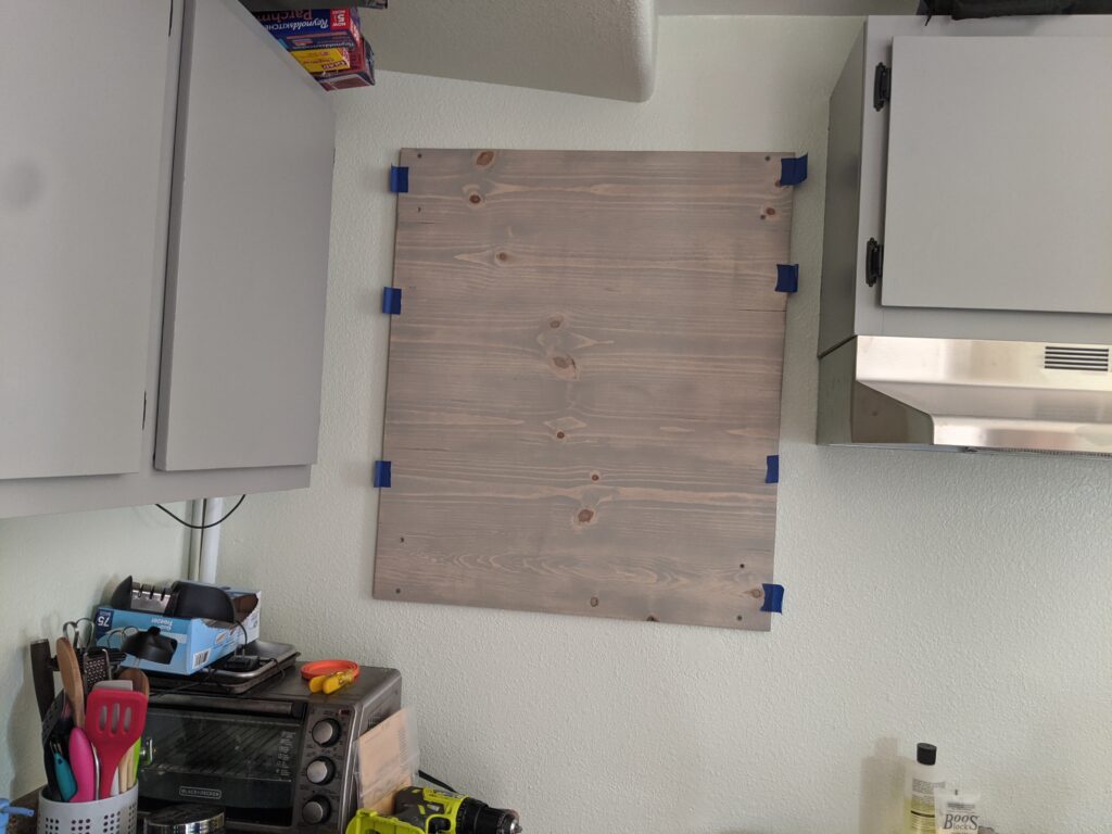 Handmade wooden panel mounted on a kitchen wall