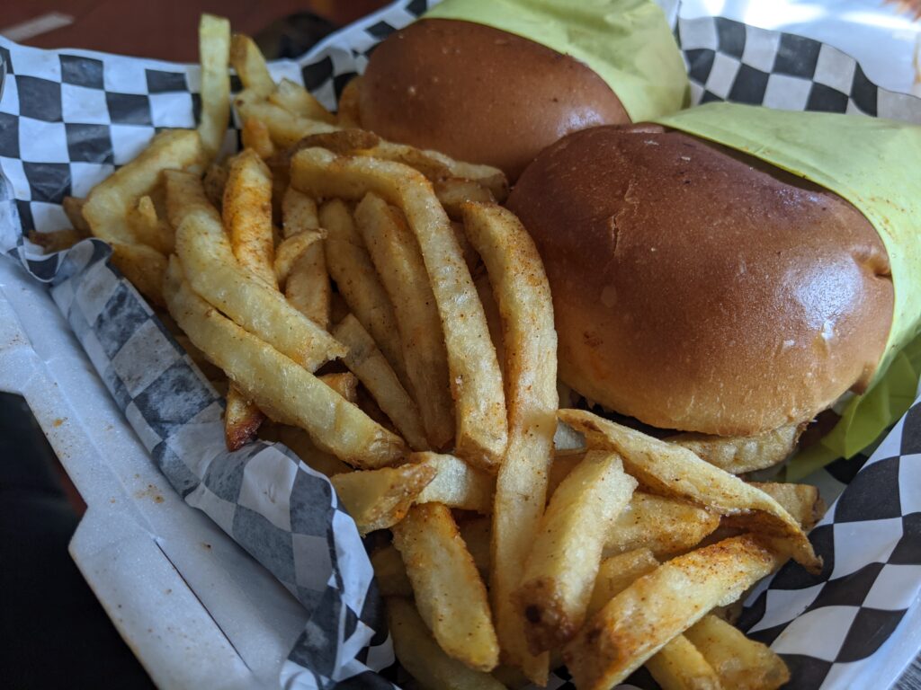 Chicken sandwich on a bun with fries