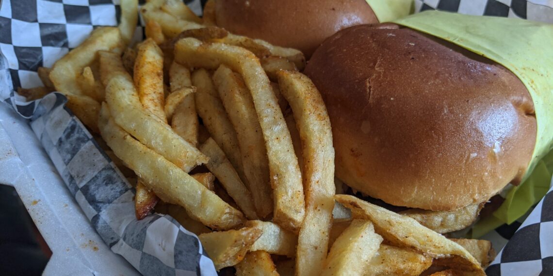 Chicken sandwich on a bun with fries