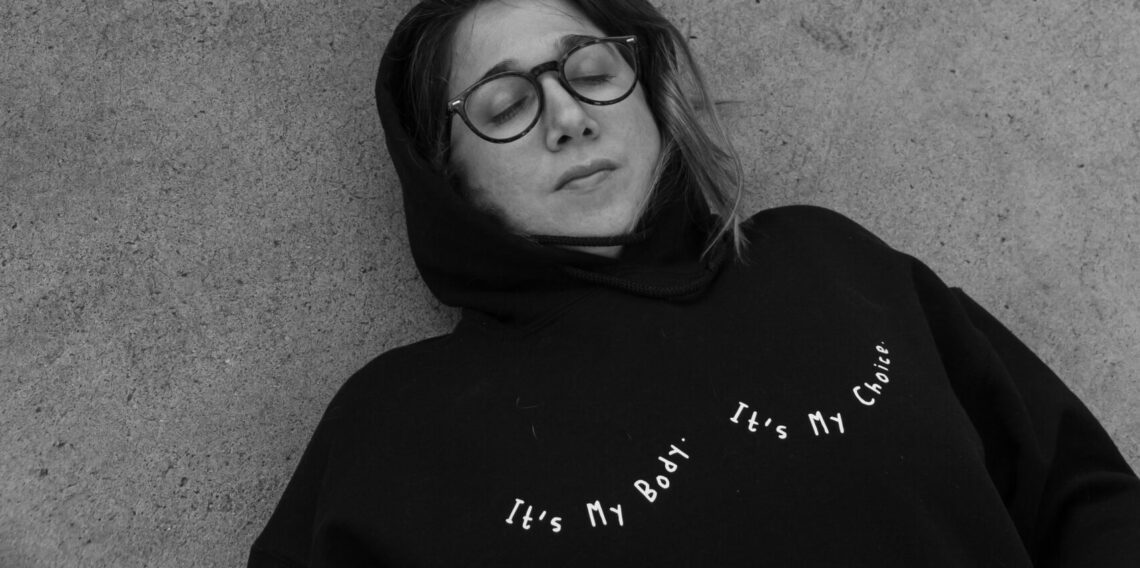 Girl wearing a sweatshirt that reads, "It's my body, It's my choice."