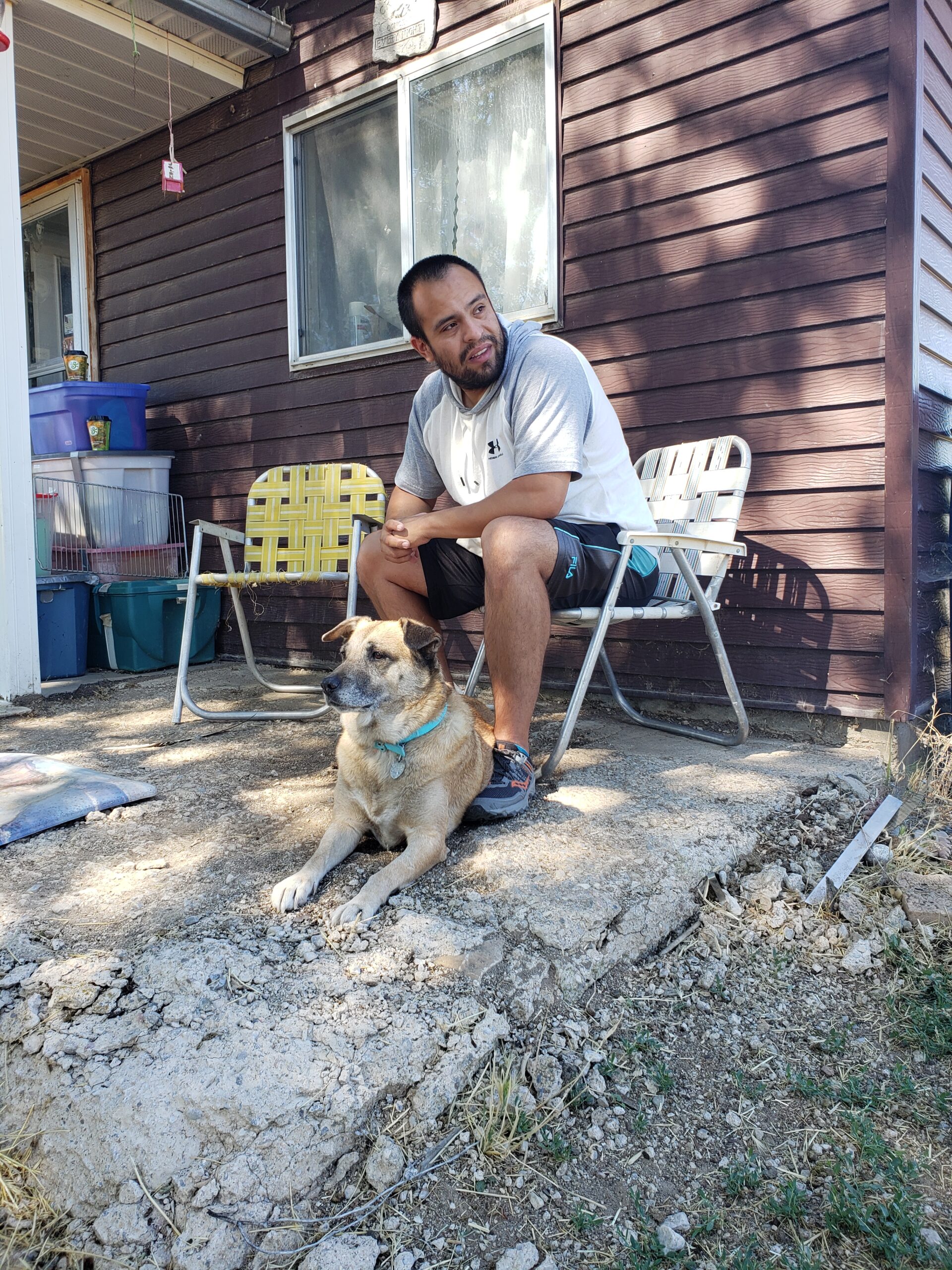 Man and his dog sitting on the front porch